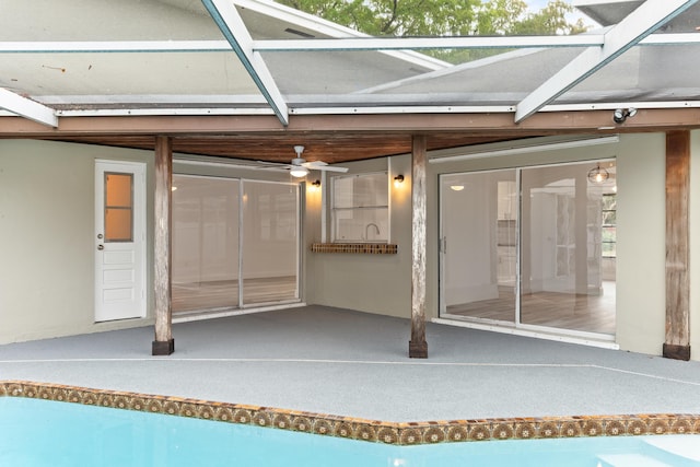 entrance to property featuring ceiling fan and a patio area