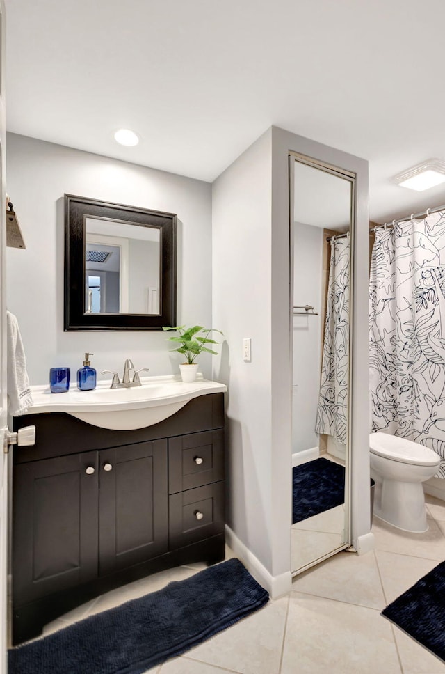bathroom with toilet, vanity, tile patterned flooring, baseboards, and recessed lighting