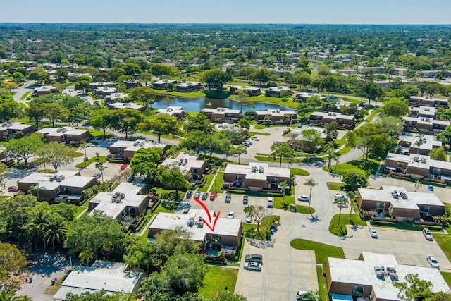 drone / aerial view featuring a residential view and a water view