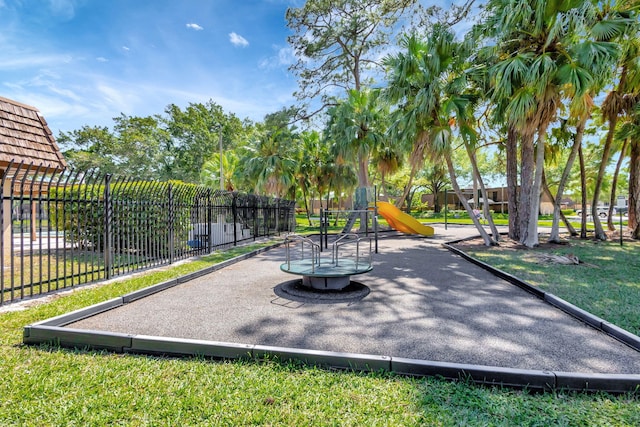 community playground featuring fence and a lawn