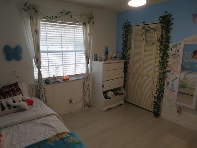 5372 Pine Cir, Coral Springs, FL 33067 - bedroom featuring light wood-type flooring, a closet, and baseboards