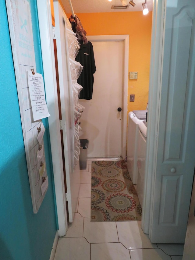 5372 Pine Cir, Coral Springs, FL 33067 - laundry room featuring washing machine and clothes dryer, light tile patterned floors, and baseboards