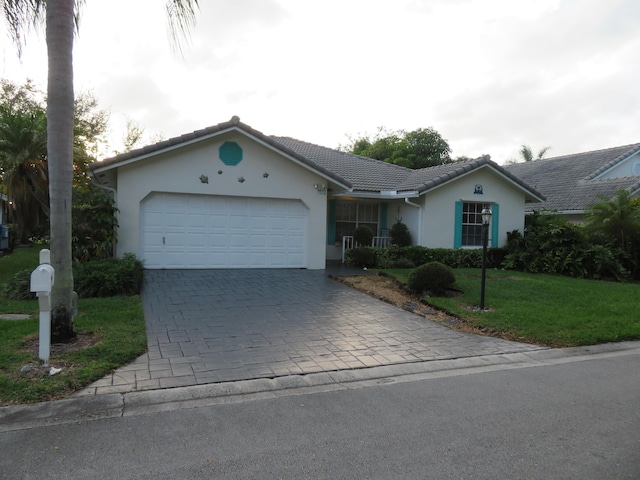 5372 Pine Cir, Coral Springs, FL 33067 - single story home featuring a garage, decorative driveway, stucco siding, a front yard, and a tiled roof