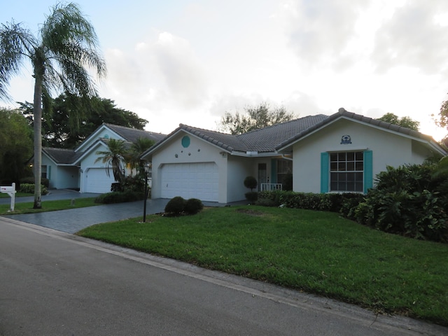 5372 Pine Cir, Coral Springs, FL 33067 - ranch-style house with stucco siding, driveway, a garage, a front lawn, and a tiled roof