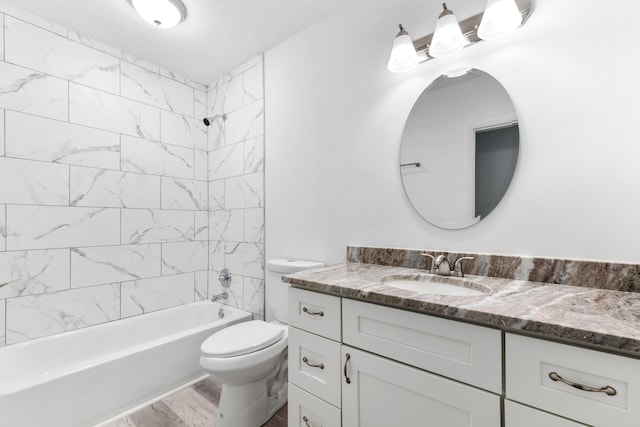 bathroom with toilet, shower / bathing tub combination, and vanity