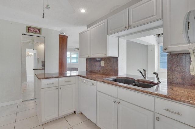 1304 SW 23rd St, Boynton Beach, FL 33426 - kitchen featuring dishwasher, a sink, light tile patterned floors, backsplash, and white cabinetry
