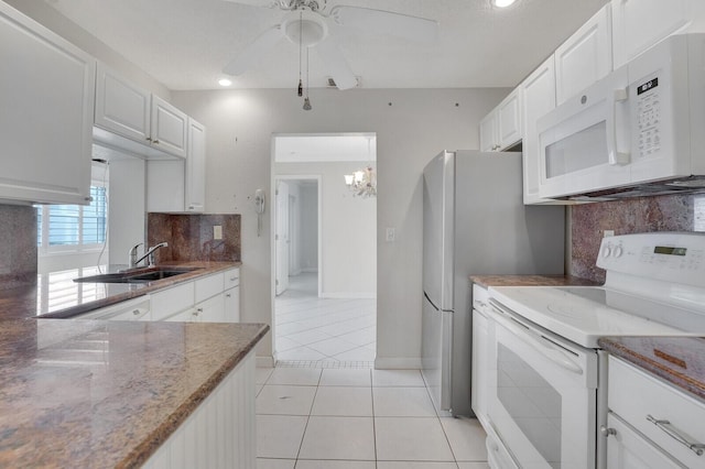 1304 SW 23rd St, Boynton Beach, FL 33426 - kitchen featuring white appliances, a sink, light tile patterned floors, backsplash, and light stone countertops