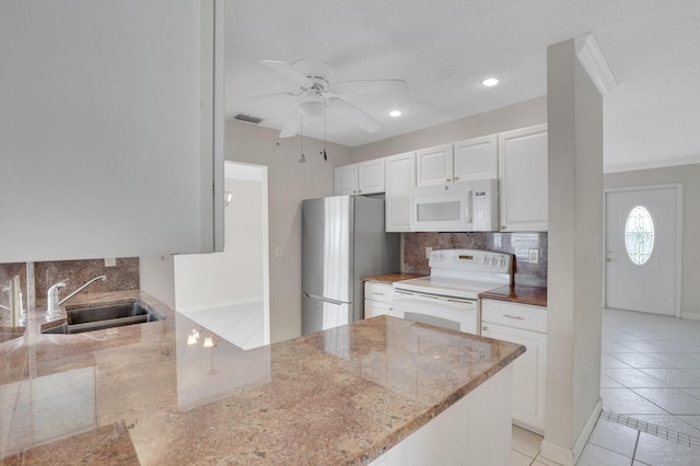 1304 SW 23rd St, Boynton Beach, FL 33426 - kitchen with white appliances, a sink, decorative backsplash, light stone countertops, and light tile patterned floors