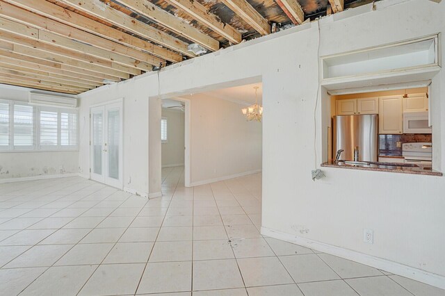 1304 SW 23rd St, Boynton Beach, FL 33426 - unfurnished room featuring light tile patterned flooring, a chandelier, and baseboards
