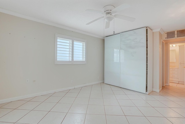 1304 SW 23rd St, Boynton Beach, FL 33426 - unfurnished bedroom featuring crown molding, baseboards, a closet, a ceiling fan, and light tile patterned floors