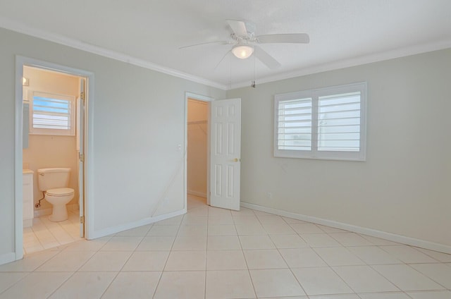 1304 SW 23rd St, Boynton Beach, FL 33426 - unfurnished bedroom featuring ornamental molding, light tile patterned flooring, a walk in closet, and baseboards