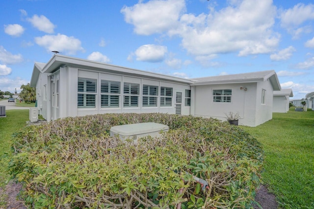1304 SW 23rd St, Boynton Beach, FL 33426 - back of property with a lawn and stucco siding