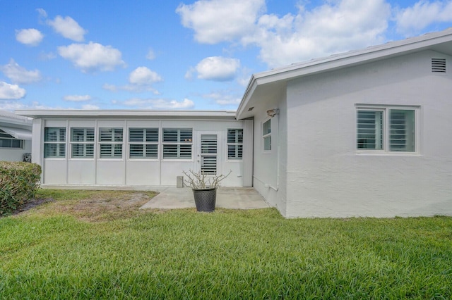 1304 SW 23rd St, Boynton Beach, FL 33426 - back of house with a yard, stucco siding, and a patio