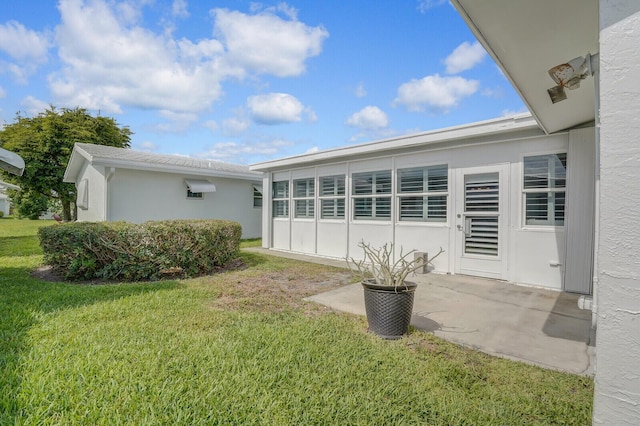 1304 SW 23rd St, Boynton Beach, FL 33426 - back of property with a lawn, a patio, and stucco siding