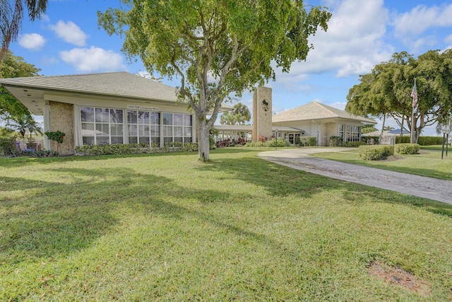 1304 SW 23rd St, Boynton Beach, FL 33426 - view of front facade featuring a front lawn and a tile roof