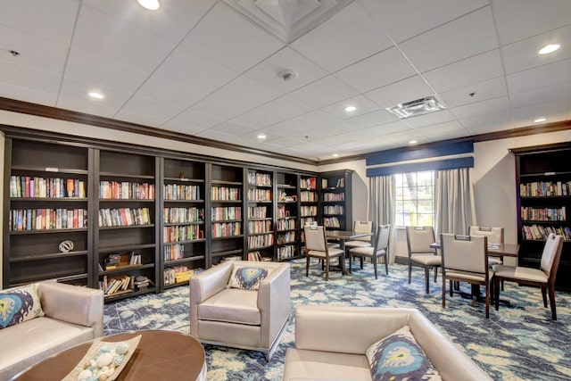 5115 Europa Dr Unit P, Boynton Beach, FL 33437 - living area with carpet flooring, visible vents, crown molding, and wall of books