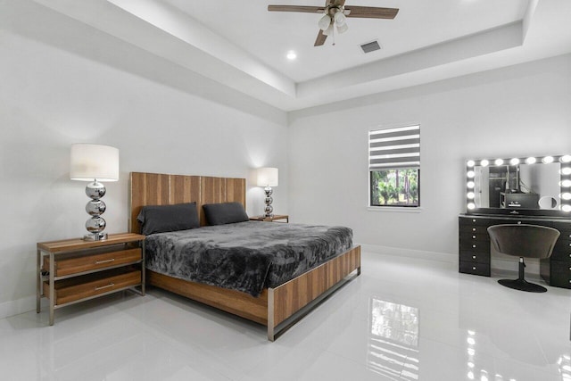 15744 68th Ct N, The Acreage, FL 33470 - bedroom with tile patterned floors, visible vents, a tray ceiling, and baseboards