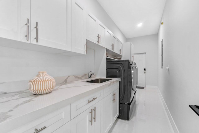 15744 68th Ct N, The Acreage, FL 33470 - laundry area featuring washing machine and dryer, baseboards, a sink, and cabinet space