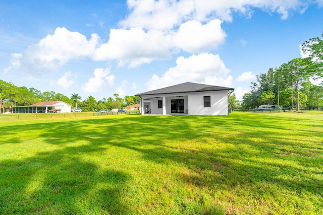 15744 68th Ct N, The Acreage, FL 33470 - rear view of property with fence, a lawn, and stucco siding