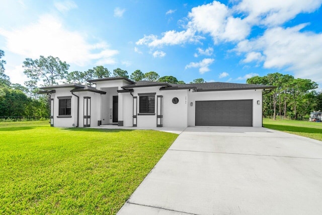 15744 68th Ct N, The Acreage, FL 33470 - view of front of property with an attached garage, concrete driveway, stucco siding, and a front lawn