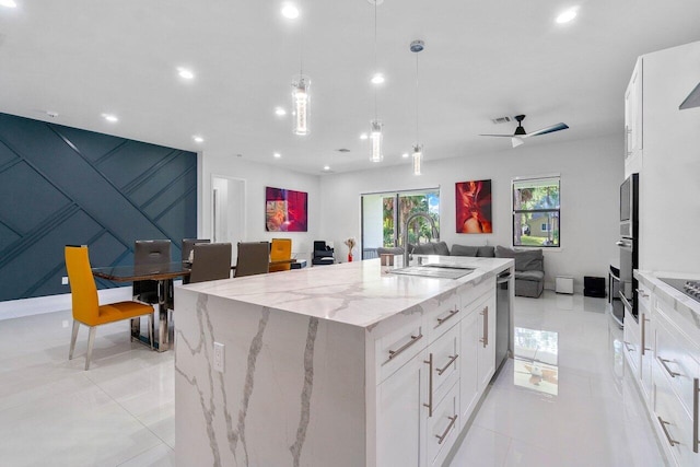 15744 68th Ct N, The Acreage, FL 33470 - kitchen with a sink, open floor plan, white cabinets, and a center island with sink