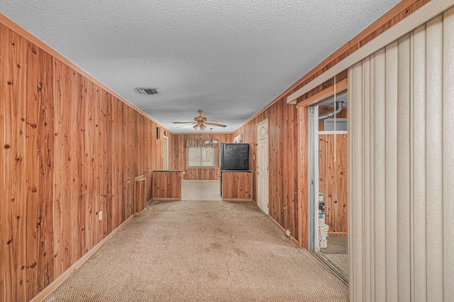 2008 Avenue Ave N, Fort Pierce, FL 34950 - corridor featuring visible vents, baseboards, carpet, a textured ceiling, and wood walls