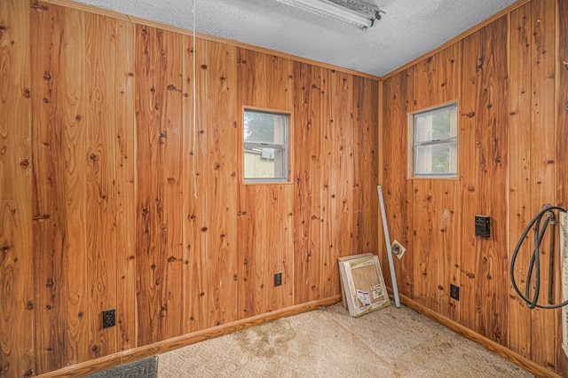 2008 Avenue Ave N, Fort Pierce, FL 34950 - carpeted spare room with crown molding, wood walls, baseboards, and a textured ceiling