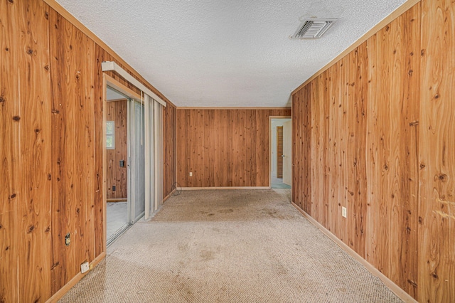 2008 Avenue Ave N, Fort Pierce, FL 34950 - corridor with wood walls, visible vents, and a textured ceiling