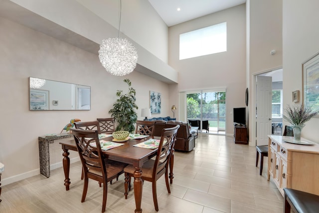 9339 World Cup Way, Port Saint Lucie, FL 34986 - dining area featuring a towering ceiling, a chandelier, and baseboards