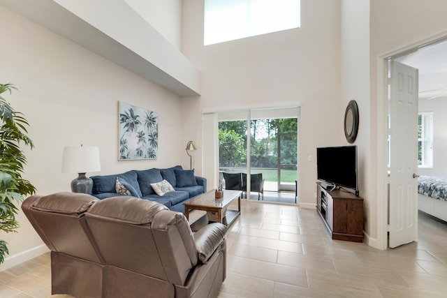 9339 World Cup Way, Port Saint Lucie, FL 34986 - living area featuring a towering ceiling, healthy amount of natural light, and baseboards