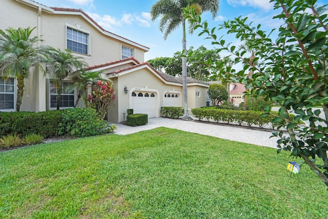 9339 World Cup Way, Port Saint Lucie, FL 34986 - mediterranean / spanish-style house with a garage, stucco siding, decorative driveway, and a front yard