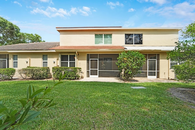 9339 World Cup Way, Port Saint Lucie, FL 34986 - back of house with stucco siding, a tiled roof, a sunroom, and a yard