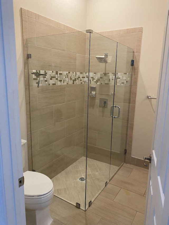 8481 NW 51st Ter, Doral, FL 33166 - bathroom featuring a stall shower and toilet