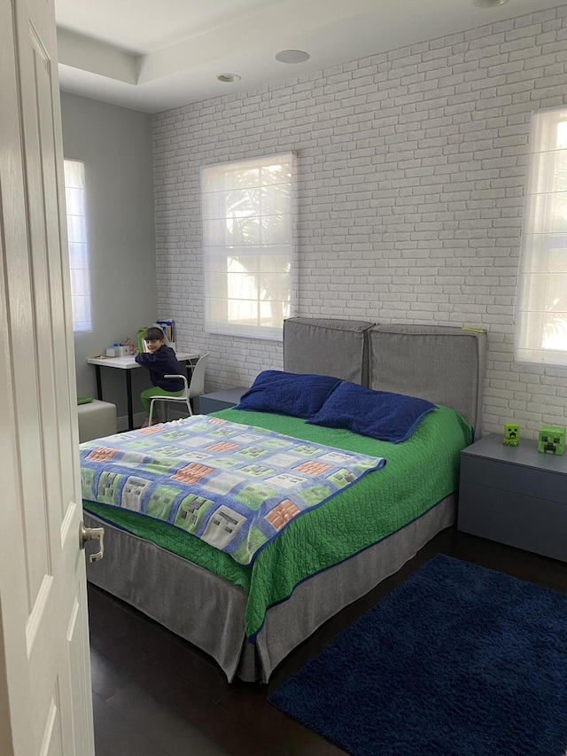 8481 NW 51st Ter, Doral, FL 33166 - bedroom with wood finished floors and brick wall
