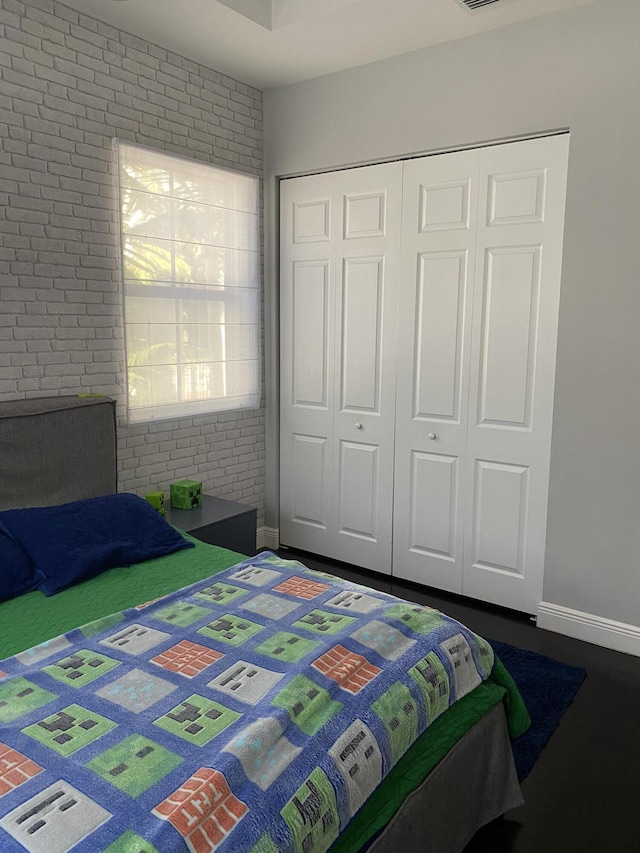 8481 NW 51st Ter, Doral, FL 33166 - bedroom featuring a closet, visible vents, baseboards, and brick wall