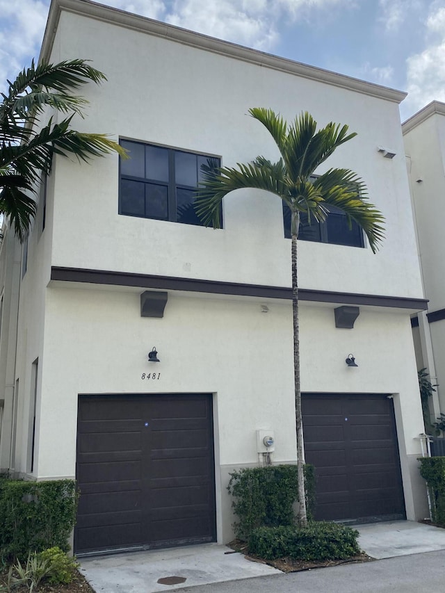 8481 NW 51st Ter, Doral, FL 33166 - view of front facade with stucco siding, a garage, and concrete driveway