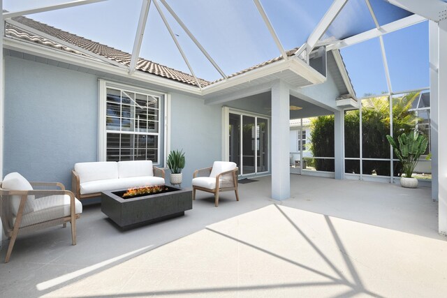 551 NW Red Pine Way, Jensen Beach, FL 34957 - view of patio / terrace featuring an outdoor living space with a fire pit and a lanai