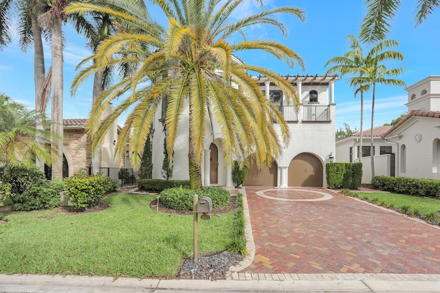 9387 Satinleaf Pl, Parkland, FL 33076 - mediterranean / spanish-style home featuring a balcony, curved driveway, stucco siding, a front lawn, and a garage