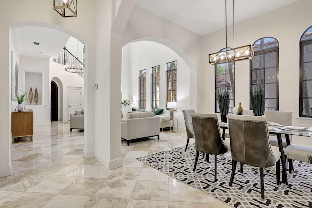 9387 Satinleaf Pl, Parkland, FL 33076 - dining space featuring baseboards, an inviting chandelier, a high ceiling, and marble finish floor