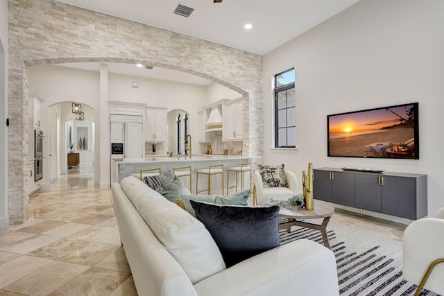 9387 Satinleaf Pl, Parkland, FL 33076 - living area with baseboards, visible vents, arched walkways, and recessed lighting