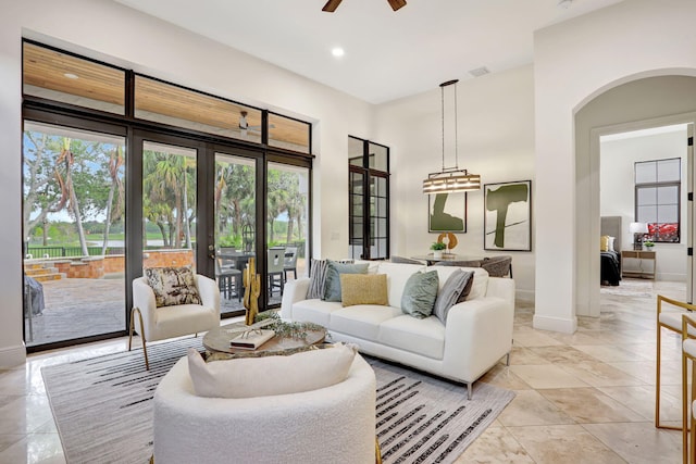 9387 Satinleaf Pl, Parkland, FL 33076 - living area featuring a wealth of natural light, a ceiling fan, baseboards, and arched walkways