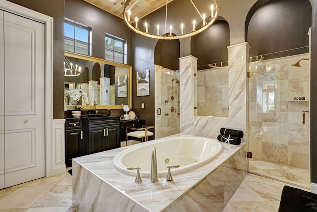 9387 Satinleaf Pl, Parkland, FL 33076 - bathroom with a tub with jets, a chandelier, marble finish floor, vanity, and a stall shower