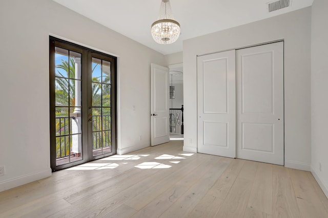 9387 Satinleaf Pl, Parkland, FL 33076 - interior space featuring a notable chandelier, visible vents, baseboards, and light wood-style floors