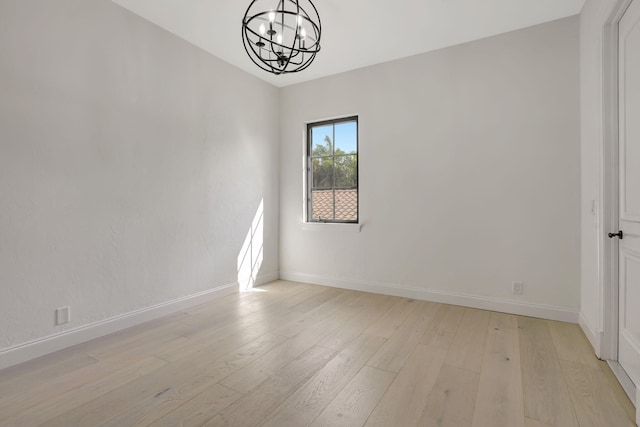 9387 Satinleaf Pl, Parkland, FL 33076 - empty room with baseboards, a notable chandelier, and light wood-style floors