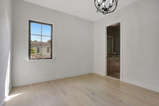 9387 Satinleaf Pl, Parkland, FL 33076 - unfurnished room with a chandelier, light wood-type flooring, and baseboards