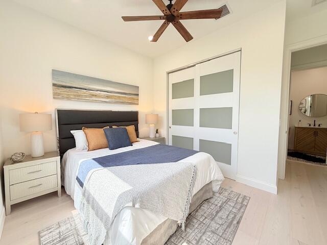 9387 Satinleaf Pl, Parkland, FL 33076 - bedroom with ceiling fan, light wood finished floors, and a closet