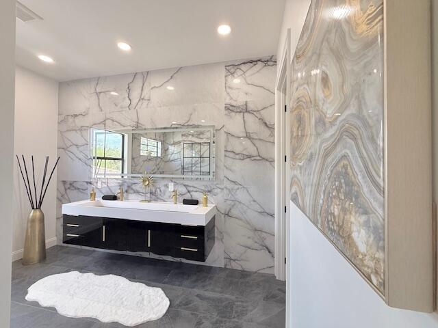 9387 Satinleaf Pl, Parkland, FL 33076 - bathroom with recessed lighting, marble finish floor, stone wall, and vanity
