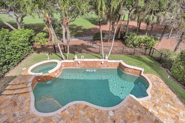 9387 Satinleaf Pl, Parkland, FL 33076 - view of swimming pool with a fenced backyard, a pool with connected hot tub, and a lawn