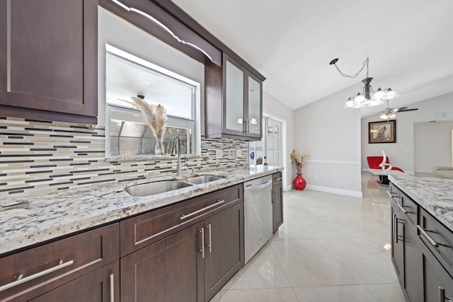 kitchen with stainless steel dishwasher, a sink, lofted ceiling, tasteful backsplash, and a chandelier