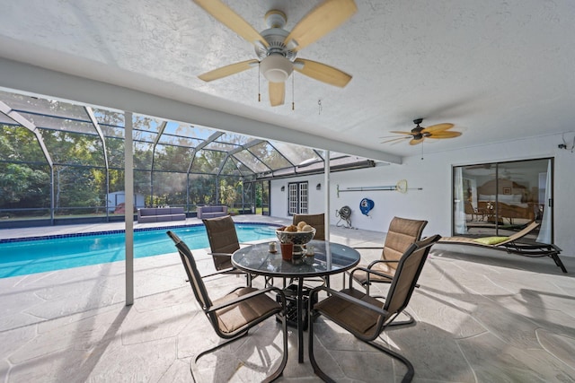 swimming pool with ceiling fan, a patio, and a lanai